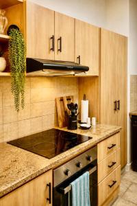 a kitchen with wooden cabinets and a stove top oven at 2 at Sunset View in Langstrand