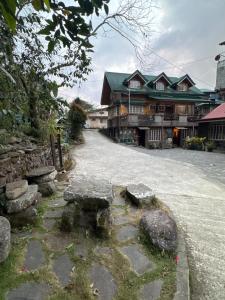 a stone path in front of a large building at Sagada Pinewood Lodge basement in Sagada