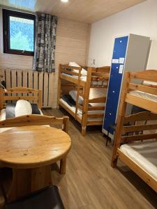 a room with several bunk beds and tables and a window at Alpenrose Chamonix in Chamonix +12 photos