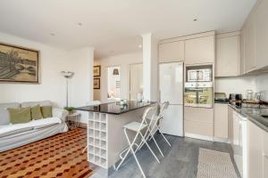 a kitchen and living room with a couch and a table at Santarem Terrace by Homing in Santarém +20 photos