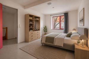 a bedroom with a large bed and a window at Elementa City Lodge Quedlinburg 1 in Quedlinburg