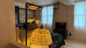 a bedroom with a bed and a large mirror at Maison Romy in Chinon