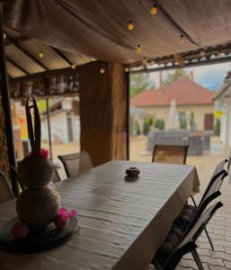 a stuffed rabbit sitting on a table in a house at Gém Home Vendégház in Bodony