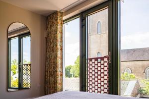 a bedroom with a window with a view of a church at Market Square in Monasterevin