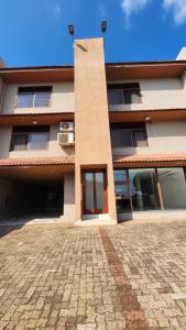 a building with a brick driveway in front of it at ORO - Boutique Guesthouse in Matola