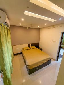 a bedroom with a bed in a room at Grand Retreat in Trichūr