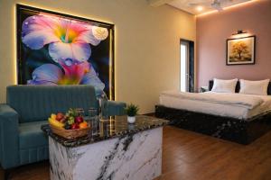 a hotel room with a bed and a table with fruit at Hotel Amarsar Palace in Amarsar