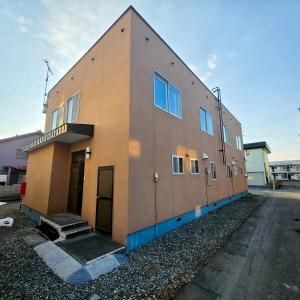 a building that is sitting on the side of a street at Snow Veil Iwamizawa in Iwamizawa
