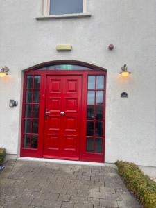 a red door on the side of a building at Nile Lodge in Galway