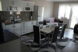 a kitchen with a table and chairs in a kitchen at Smestaj Djordjevic in Pirot