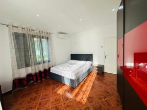 a bedroom with a bed in the middle of a room at Vila Rexhepaj in Vlorë