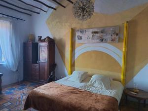 a bedroom with a large bed with a wooden headboard at La Maison des Artistes in Essaouira +107 photos