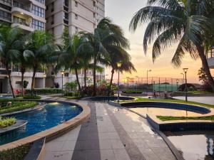 a resort with palm trees and a swimming pool at Country Garden Danga Bay By Widebed JB in Johor Bahru