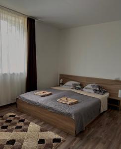 a bedroom with a bed with two plates on it at Gém Home Vendégház in Bodony +40 photos