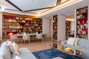 a living room with a couch and a table at Hotel Astra Opera - Astotel in Paris