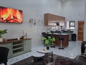a living room with a kitchen with a fireplace at Ficus self catering in Burgersfort