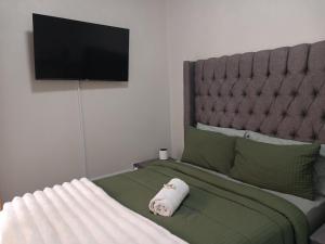 a bedroom with a bed with a towel on it at Ficus self catering in Burgersfort