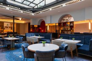 a dining room with tables and chairs at Hotel Astra Opera - Astotel in Paris