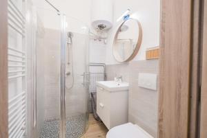 a bathroom with a shower and a toilet and a sink at Corso Apartman in Siófok +18 photos