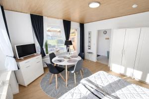 a bedroom with a bed and a table and chairs at Haus Sternenstrand Tossens in Tossens