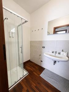 a bathroom with a sink and a glass shower at Emilia's Lakeview Terrace in Brienno