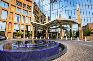 a large building with a fountain in front of it at شقة برج رافال Rafal Tower in Riyadh