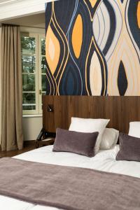 a bedroom with a large bed with a wall at Château Du Mont Joly in Sampans