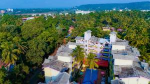 an aerial view of a city with palm trees at Joystays Renton Manor in Arpora