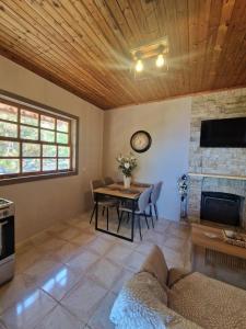 a living room with a table and a fireplace at Peter's Village in Kalamaki Messinia