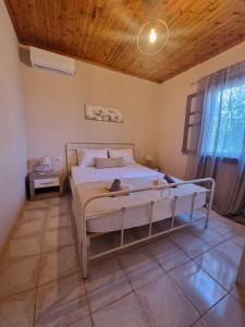a bedroom with a bed with a wooden ceiling at Peter's Village in Kalamaki Messinia