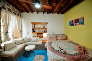 a bedroom with a large bed and a couch at Mastoris Mansion in Hydra