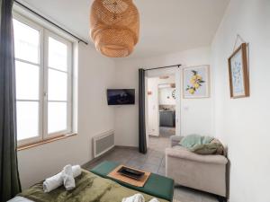 a living room with a bed and a couch at Le Pont Ravet in Bernay