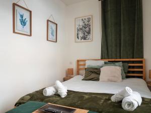 a bedroom with a bed with towels on it at Le Pont Ravet in Bernay