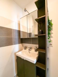 a bathroom with a sink and a mirror at Le Pont Ravet in Bernay +18 photos