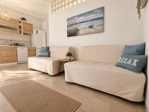 a living room with a couch and a kitchen at Apartment Dolphin Sea View and First Line in Hanioti