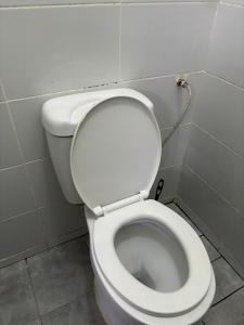 a bathroom with a white toilet in a stall at Studio Kilifi -Pendoraha Homes in Kilifi +10 photos