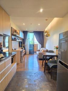 a living room with a kitchen and a dining room at Blue Sky Private Pool Villa in Chiang Mai