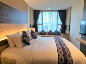 a bedroom with a large bed with pillows and a window at Blue Sky Private Pool Villa in Chiang Mai +19 photos