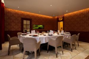 a dining room with a white table and chairs at Château Du Mont Joly in Sampans +15 photos