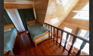 a room with a balcony in a log cabin at Terelj Khangai Resort in Belen Hüryee Hiid