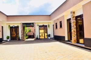 an empty courtyard of a building with glass doors at Townside Suites in Kyebando