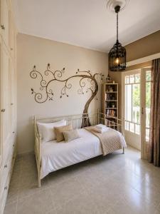 a bedroom with a bed with a wrought iron headboard at Allegoria House in Nafplio +23 photos