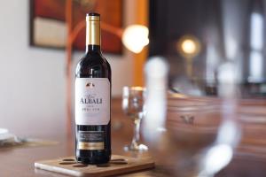 a bottle of wine on a table with a glass at Home2Book La Molina A, Cozy Terrace Retreat in Triquivijate