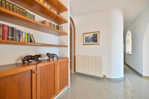 two statues on a cabinet in a room with books at LUXURY VILLA CIOVO Sleeps 17, Infinity Pool, Seafront in Trogir