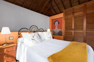 a bedroom with a large bed with white sheets and pillows at Home2Book La Molina A, Cozy Terrace Retreat in Triquivijate +19 photos