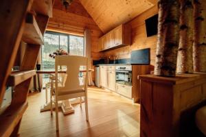 a kitchen with a table and a chair in a room at lodge 1 - les jolis chalets in Barbey-Séroux