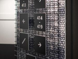 a wall with black and white signs on it at ibis Clermont Ferrand Montferrand in Clermont-Ferrand