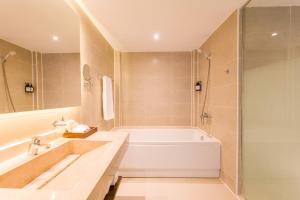 a bathroom with a tub and a sink and a shower at ananea Hurghada - Adults Only in Hurghada +159 photos