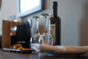 two wine glasses and a plate of food on a table at ananea Hurghada - Adults Only in Hurghada
