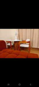 a room with red chairs and a table and a table and a tablektop at Shekhy Homes in Machakos